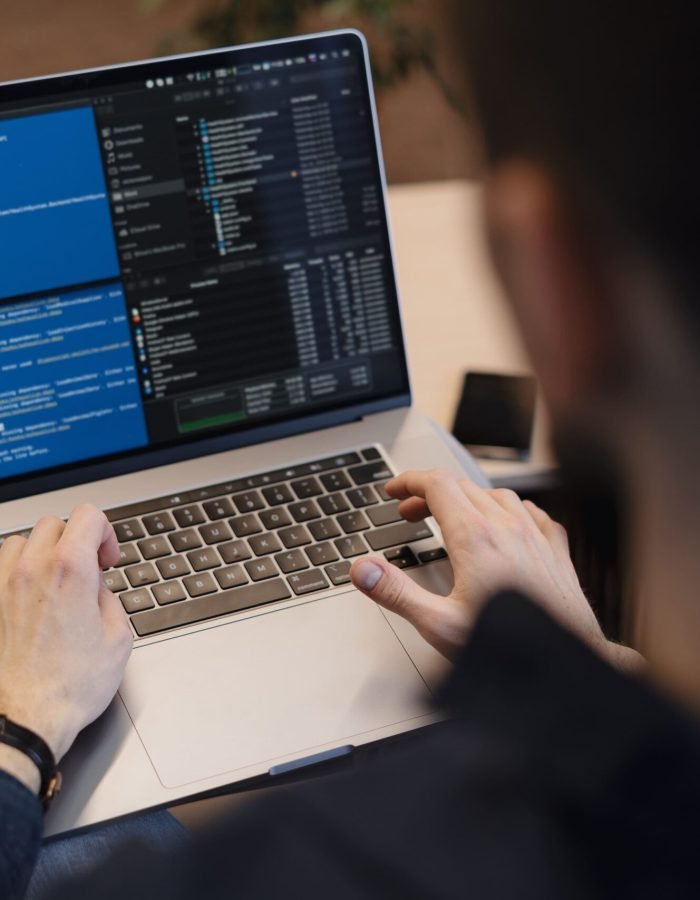 close-up-man-writing-code-laptop
